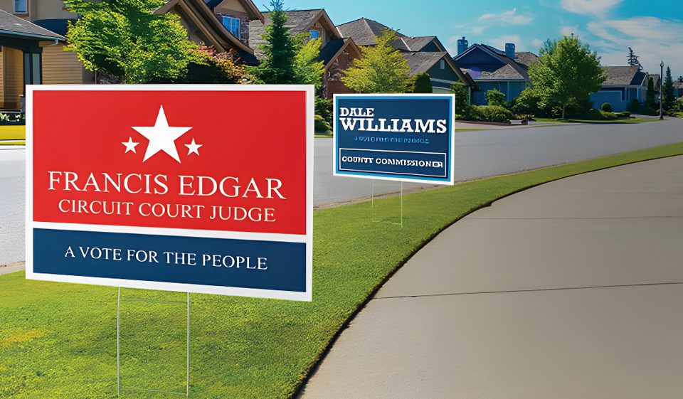 A couple of political signs on the side walk