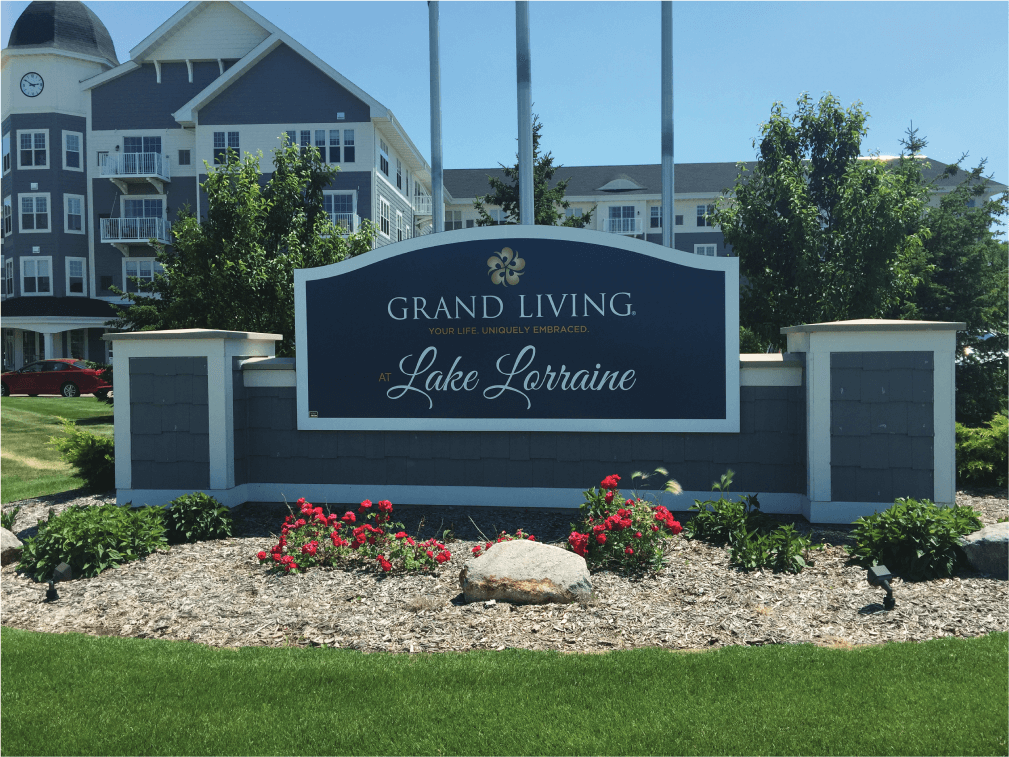 A sign that says grand living lake lorraine.