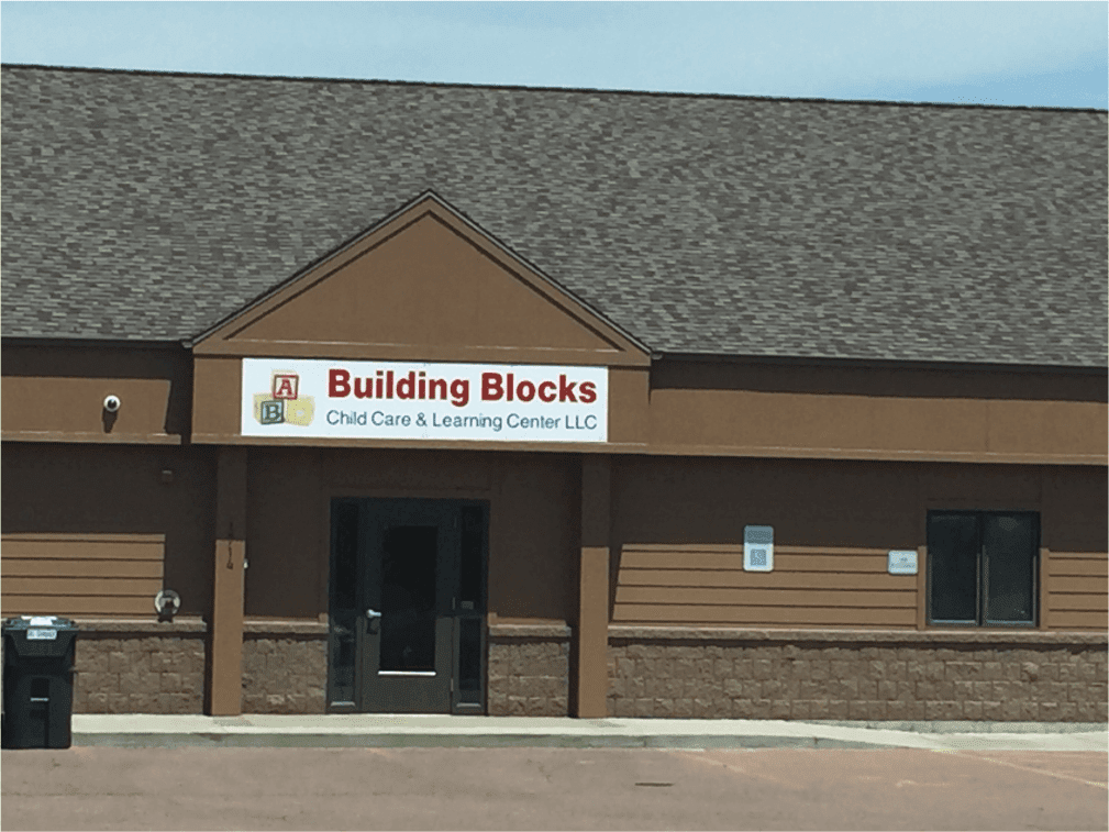 A building with a sign that says " building blocks " on it.