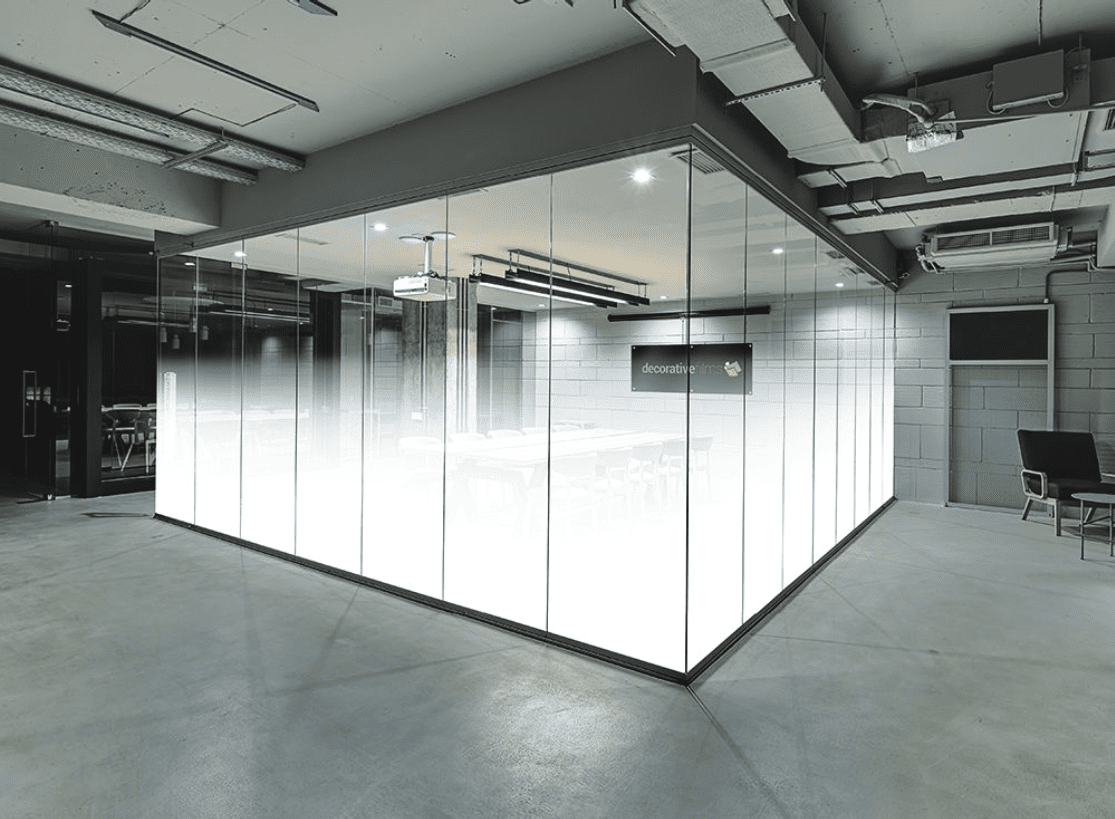 A large room with glass walls and concrete floors.